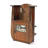 An Arts & Crafts oak hanging cabinet, the single door with a painted scene, h. 48 cm CONDITION