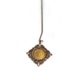 A yellow metal chainlink necklace suspending an openwork pendant set Victorian sovereign dated