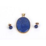 A modern yellow metal pendant of oval form set lapis lazuli,