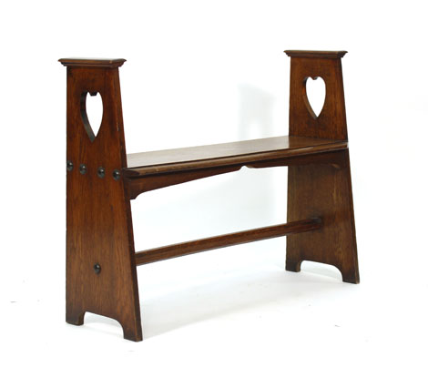 An Arts & Crafts oak bench, the two supports with heart shaped decoration and joined by a stretcher, - Image 2 of 2