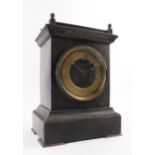 A late 19th century mantle clock, the brass face with Roman numerals within a black slate case