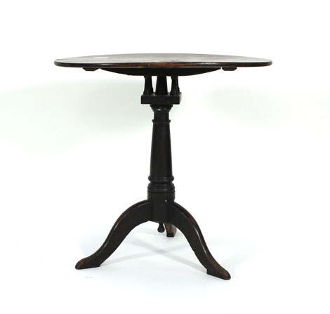 An 18th century and later oak wine table, the oval top supported by a birdcage mount on a turned