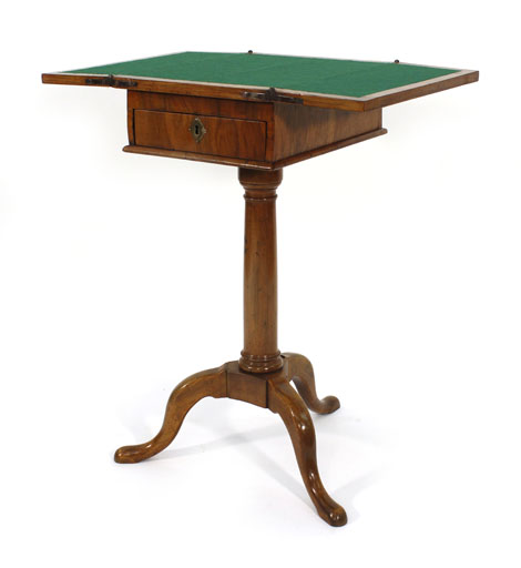 A George III walnut and crossbanded games table, the folding top over a single frieze drawer on a