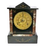 WITHDRAWN A Victorian mantel clock, the brass dial with Roman numerals,