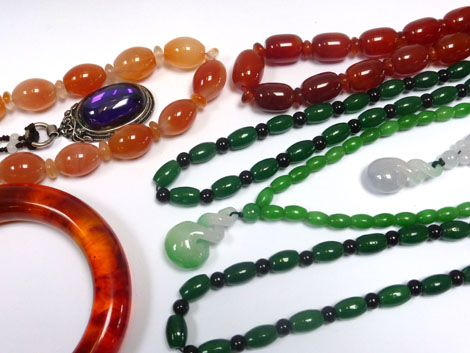A group of jade and other beaded necklaces and other items of jewellery