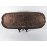 An Arts & Crafts two-handled beaten copper 'lizard' tray with impressed marks JS & SB, l. 61 cm