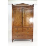 A 19th century mahogany linen press, the two doors over two short and two long drawers on turned