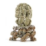 A Burmese carved figure modelled as a deity, h. 27 cm and a Chinese carved soapstone ornament in the