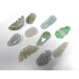 A group of ten small carved jade pendants in the form of seed pods etc, max l.