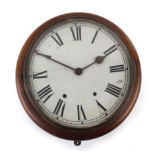 An early 20th century circular wall clock, the painted face with Roman numerals within a mahogany