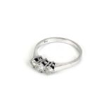 An 18ct white gold ring set three graduated diamonds, central stone approx. 0.