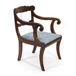 An early 19th century mahogany and upholstered carver armchair on sabre legs CONDITION REPORT: