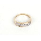 A 9ct yellow gold ring set brilliant and baguette cut diamonds in a crossover setting, 2.