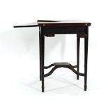 An Edwardian mahogany envelope card table on four square tapering legs joined by a central platform,