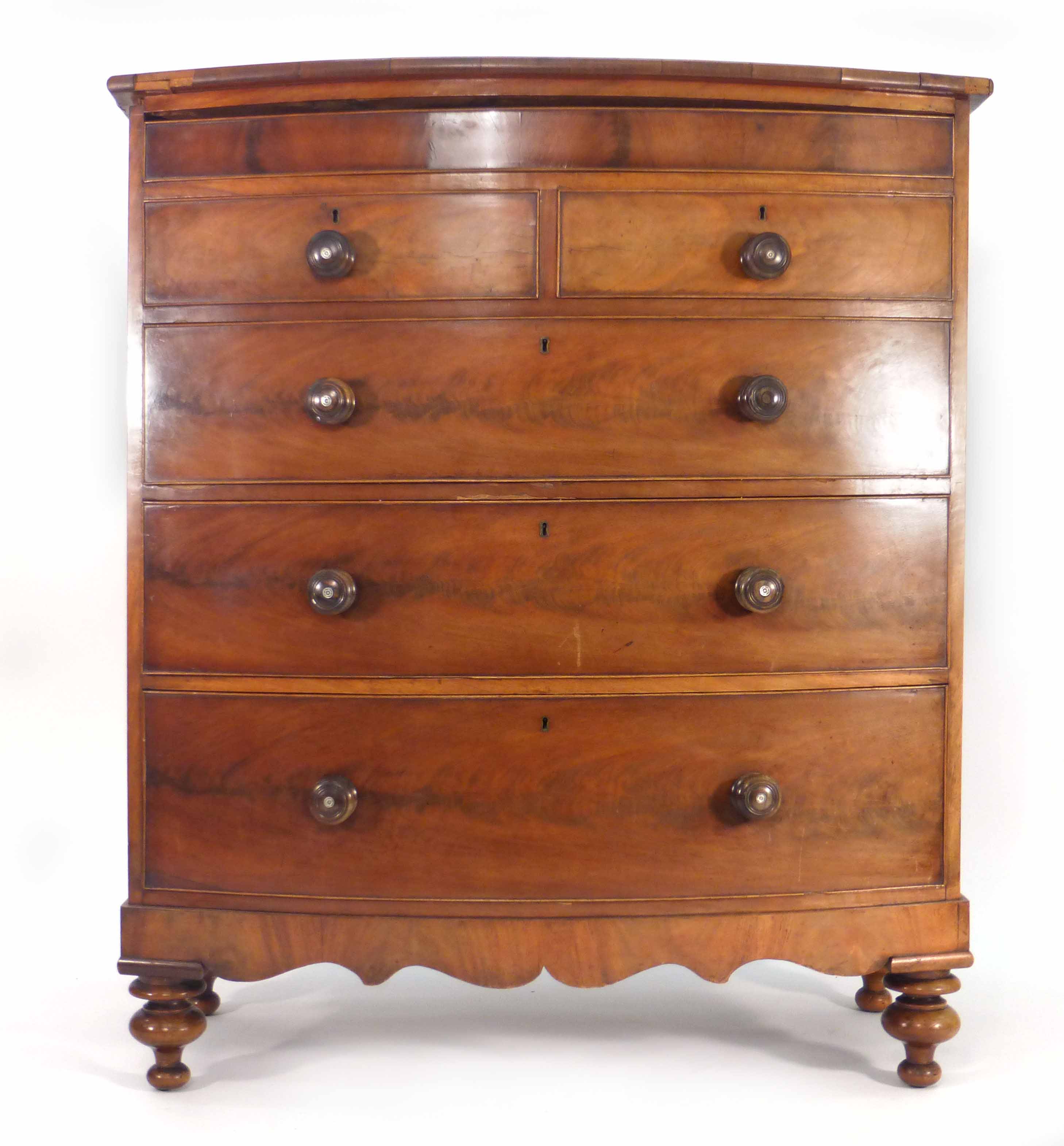 A Victorian mahogany bow fronted chest of one long over two short and three long graduated drawers