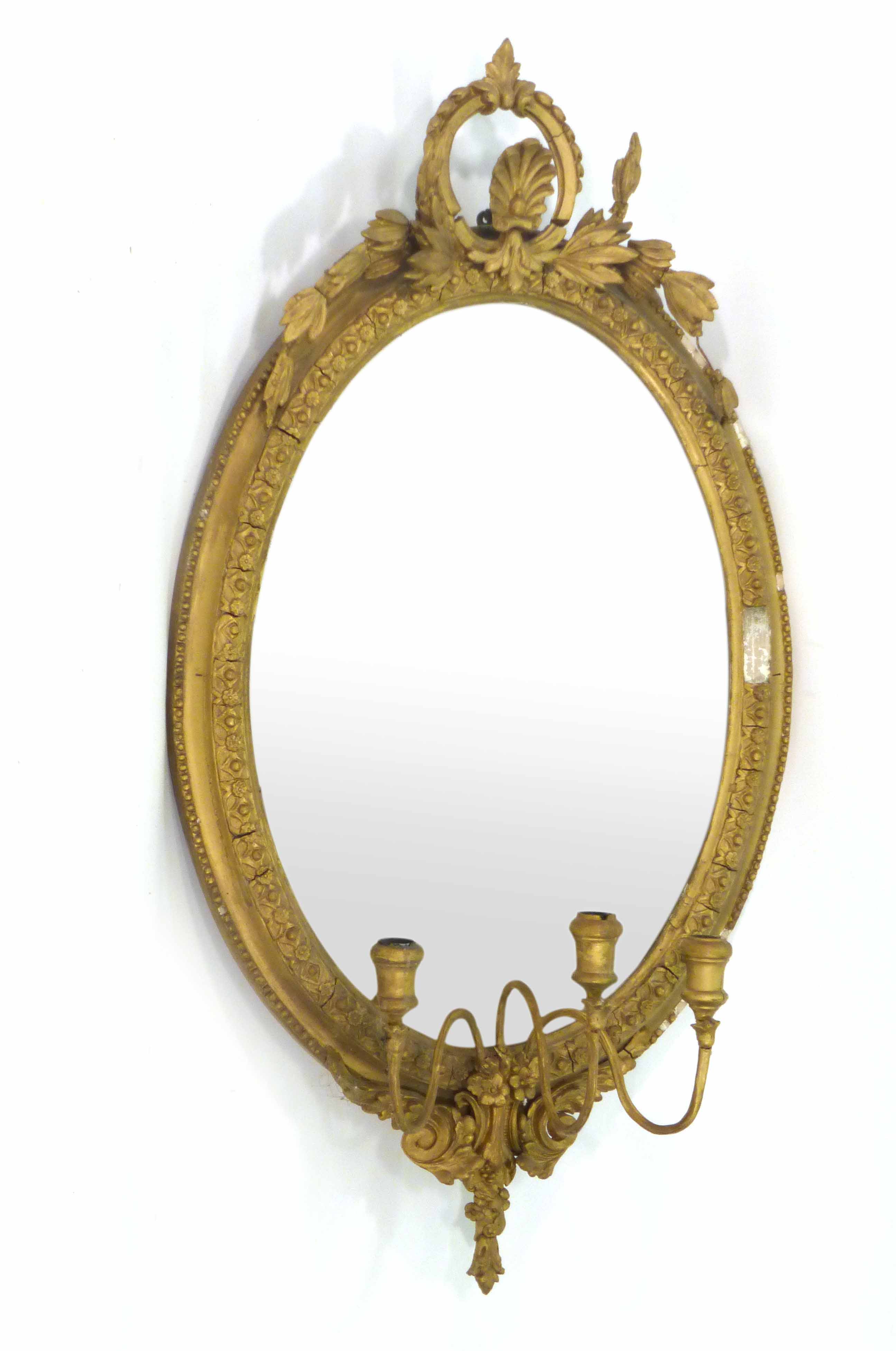 A pair of 19th century wall mirrors, the oval plate within a gilt plaster frame with three