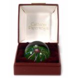 A cased Caithness glass paperweight, the green centre with concentric swirls and dated 1973