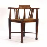 An Arts & Crafts oak corner armchair CONDITION REPORT: Wear commensurate with age, shrinkage