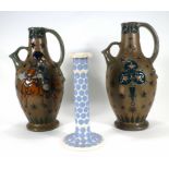 A pair of Austrian Amphora ewers of pear shaped form with strap handles and short spouts, relief