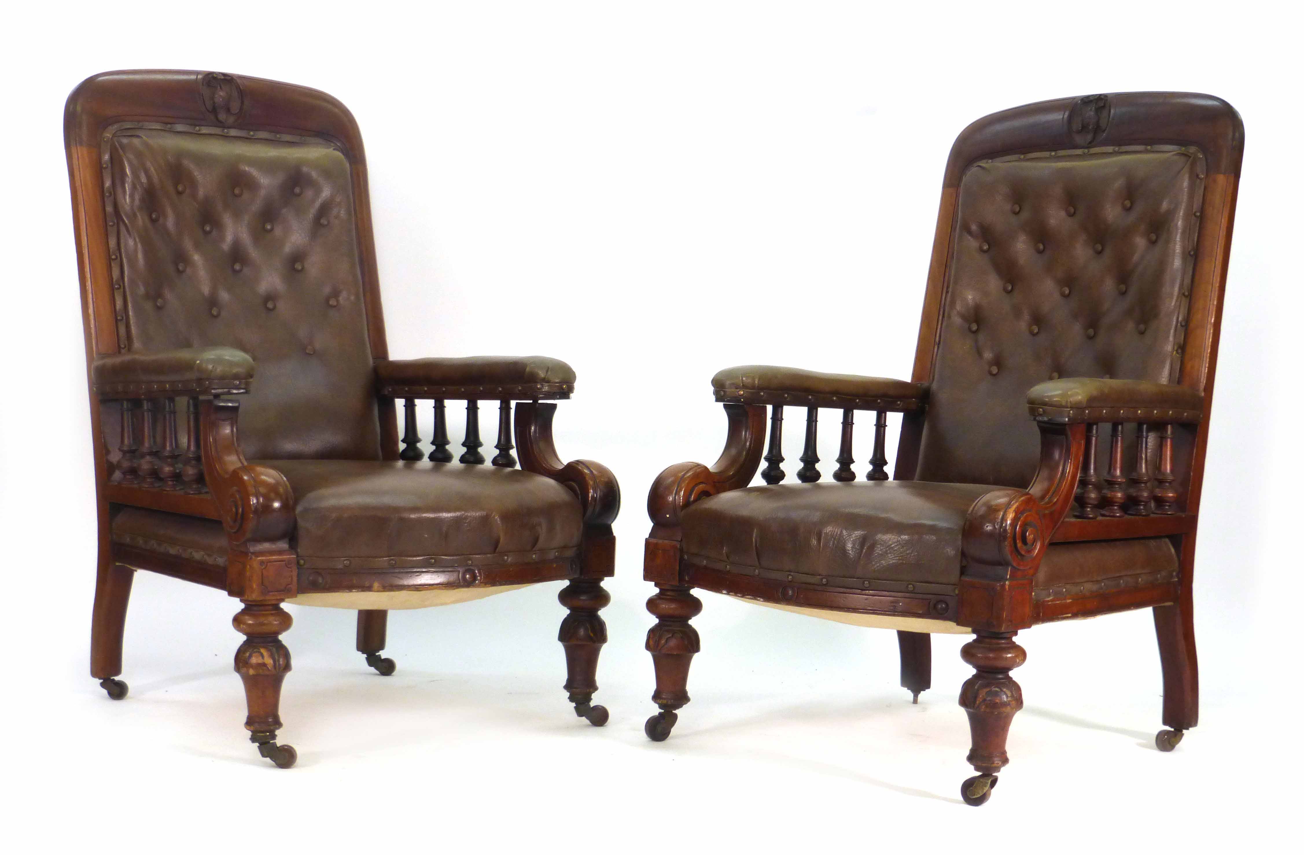 A pair of Victorian mahogany and button upholstered club armchairs on turned feet  CONDITION REPORT: