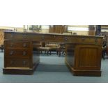 A 19th century mahogany twin pedestal partners desk, the tooled leather surface over an