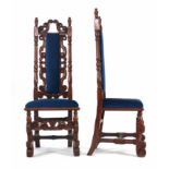 A pair of Victorian mahogany and upholstered hall chairs on figured supports joined by cross