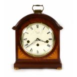 A 20th century mantle clock, the enameled face with Roman numerals within a mahogany and inlaid case