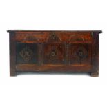 An 18th century and later panelled oak coffer with moulded frieze and carved panels, l. 113 cm