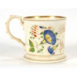 A Victorian porcelain loving cup hand decorated with roses and fuchsias, bearing the name 'Philip
