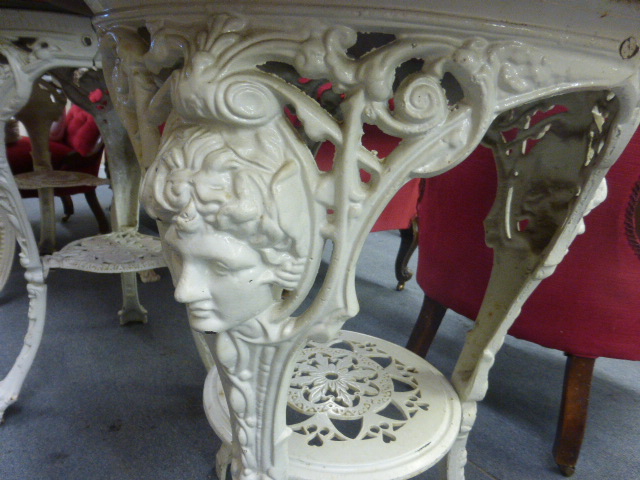 A late Victorian garden table, the mahogany circular top on a white cast iron base, the three legs - Image 6 of 10