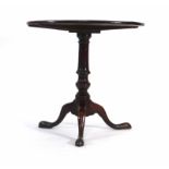 An 18th century oak tilt top supper table on a turned column with tripod base, d. 75 cm CONDITION