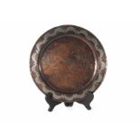 An Arts & Crafts copper plate, the raised rim with silvered decoration, by Hugh Wallace,