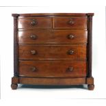 A 19th century mahogany bow fronted chest of two short and three long graduated drawers flanked by a