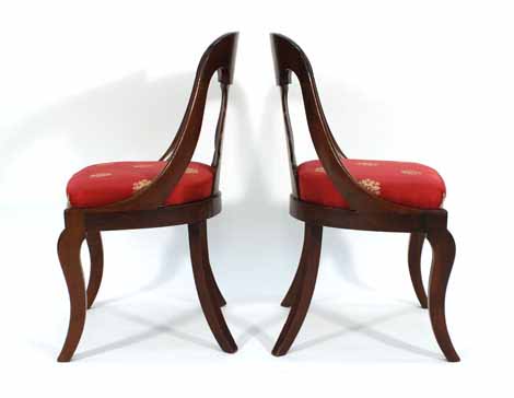 A pair of 19th century mahogany and upholstered side chairs on sabre-type legs CONDITION REPORT: