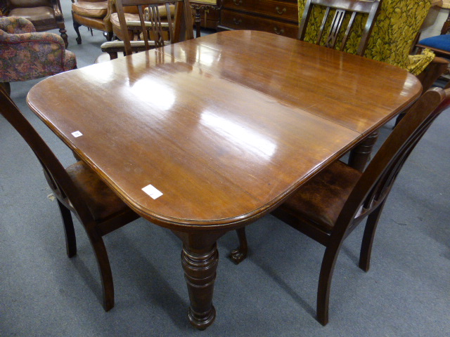 A 19th century mahogany wind out extending dining table on four turned legs, with one fitted leaf,