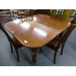 A 19th century mahogany wind out extending dining table on four turned legs, with one fitted leaf,