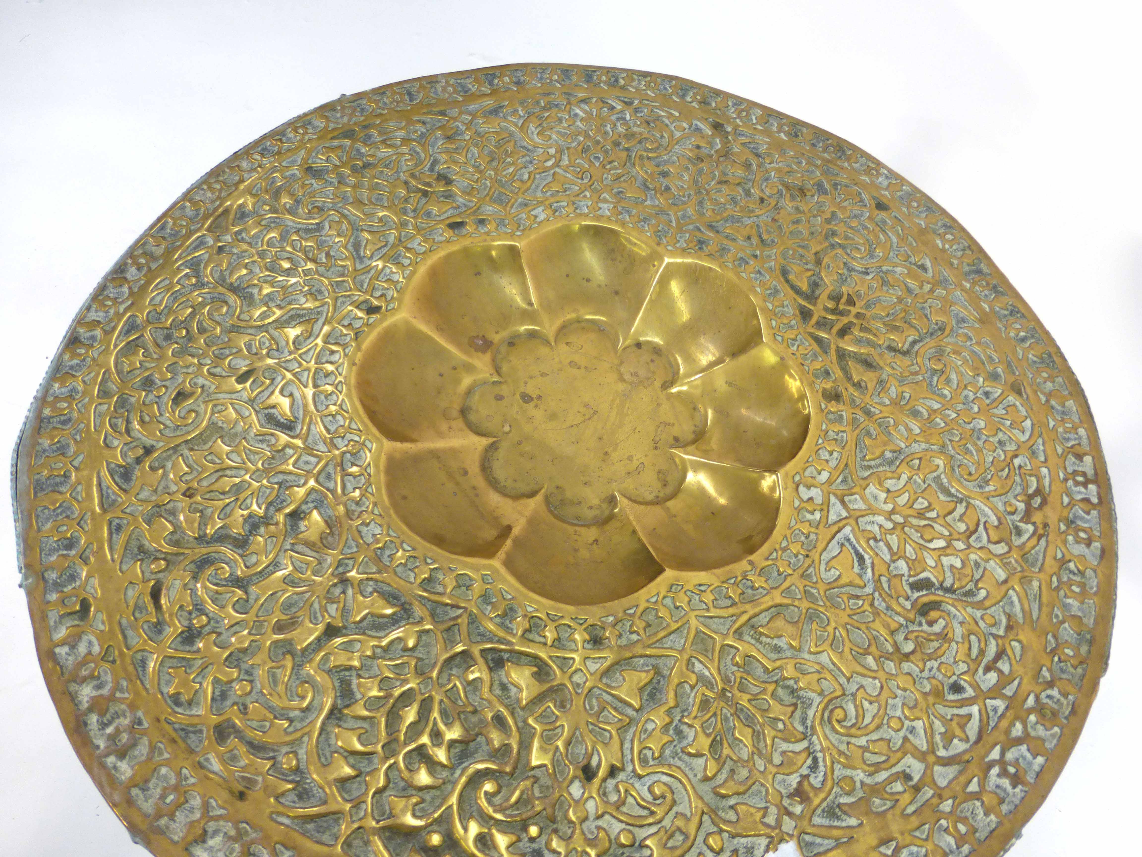 A 19th century Eastern occasional table, the brass top relief decorated with flowers on a hard - Image 2 of 2