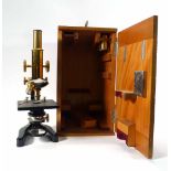 A 20th century cased brass and enameled triple microscope by Ernst Leitz Wetzlar, No. 294335, h.