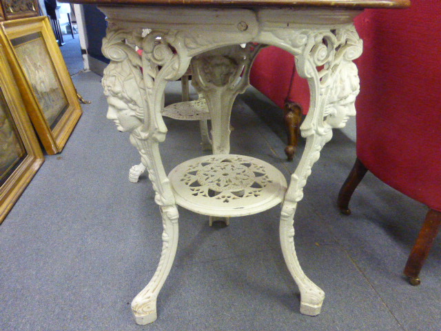 A late Victorian garden table, the mahogany circular top on a white cast iron base, the three legs - Image 3 of 10