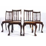 A set of twelve Edwardian mahogany dining chairs on cabriole legs with ball and claw feet