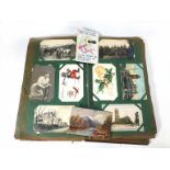 A 20th century photograph and postcard album including military pictures including a group of