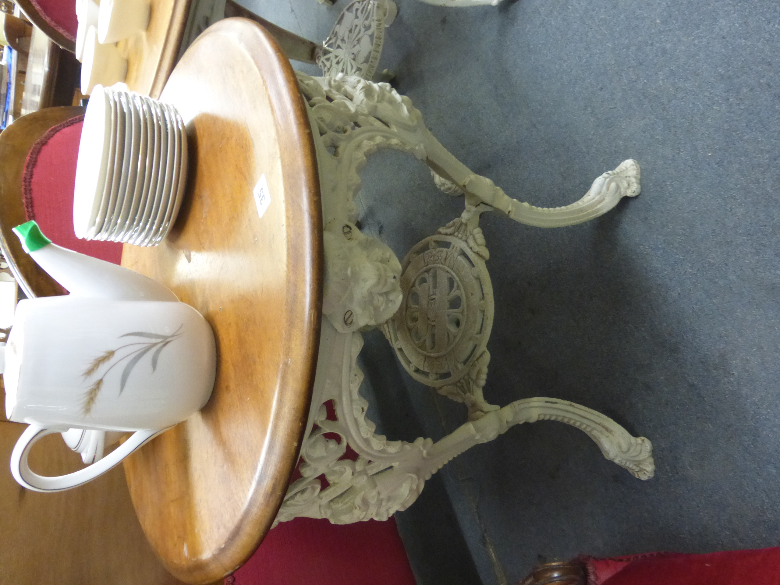 A late Victorian garden table, the mahogany circular top on a white cast iron base, the three legs - Image 3 of 15