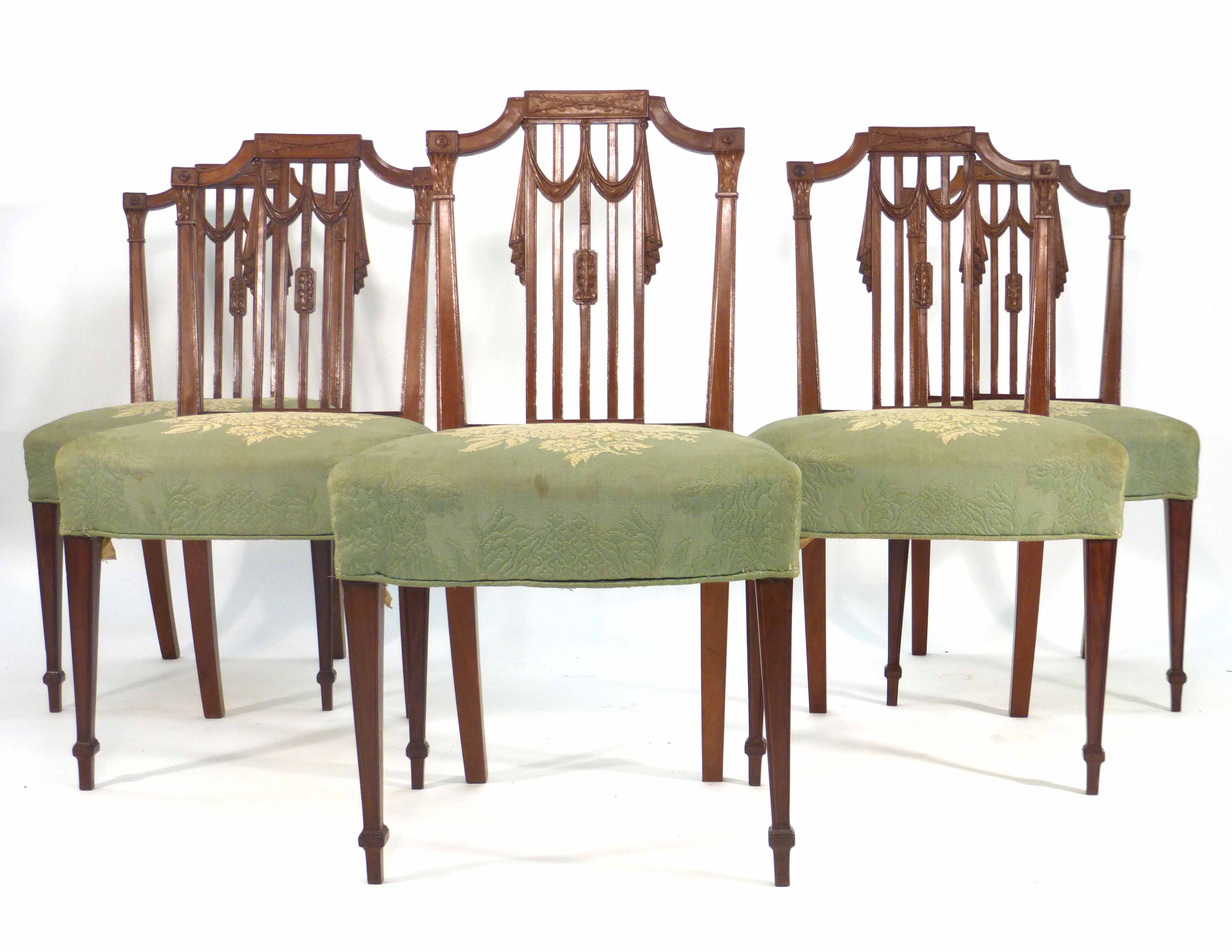 A set of five Sheraton-type mahogany and upholstered dining chairs on square tapering legs with