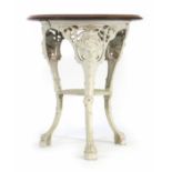 A late Victorian garden table, the mahogany circular top on a white cast iron base, the three legs