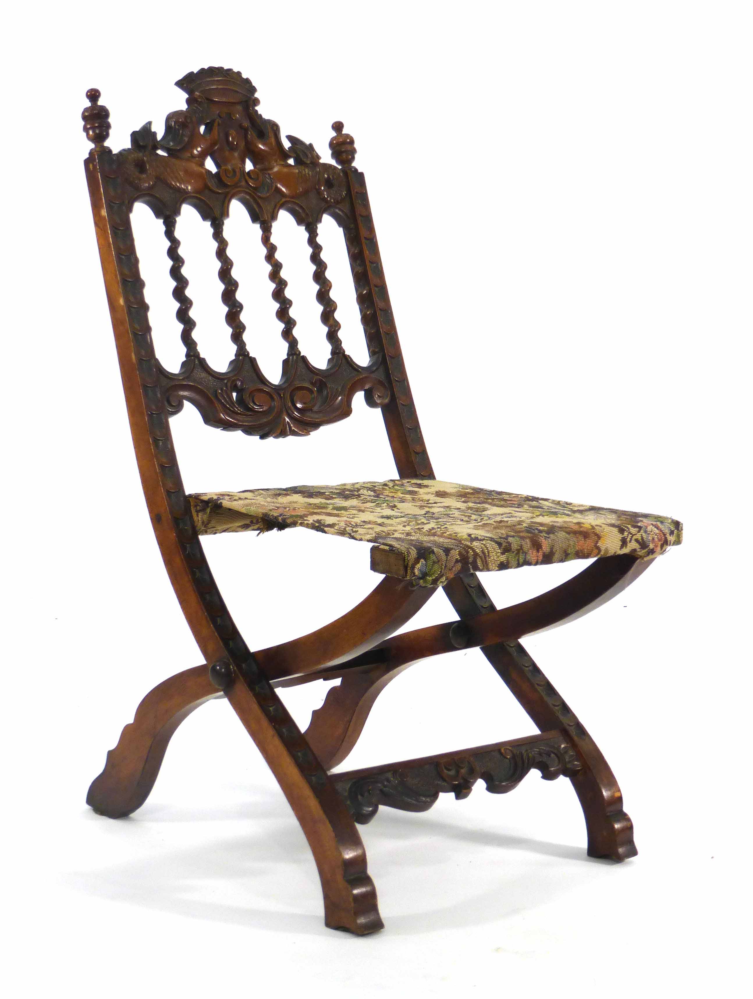 A late 19th/early 20th century beech folding campaign chair with barley twist splat and heavily