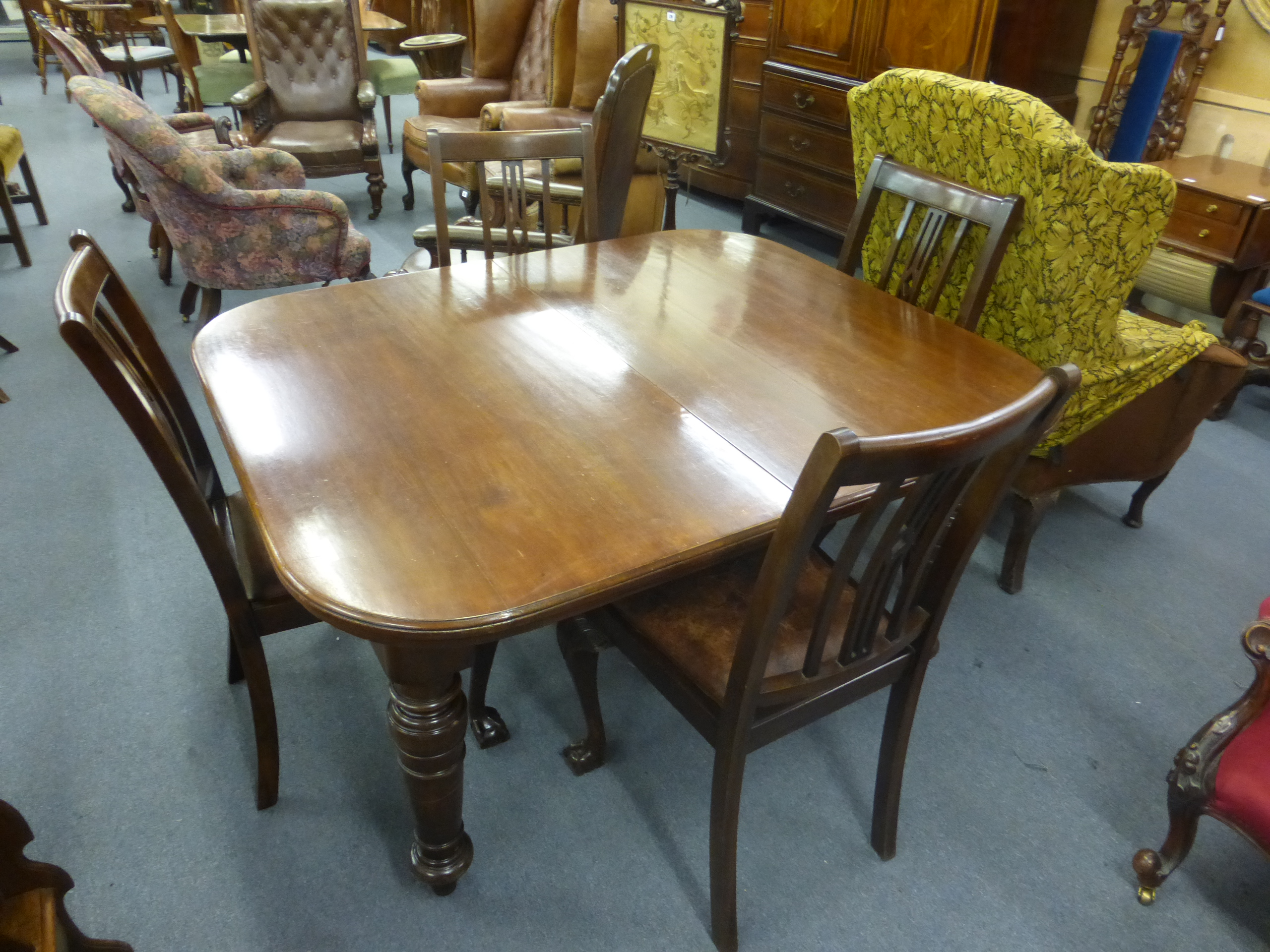 A 19th century mahogany wind out extending dining table on four turned legs, with one fitted leaf, - Image 2 of 2