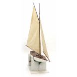 A 1920 - 1925 Woodn hull model sailing ship with a radio controlled rudder, l.