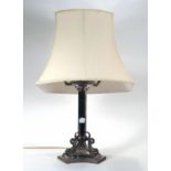 A silver plated table lamp base, the hexagonal column on a triparte base with figural supports