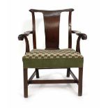 A George III mahogany and upholstered open armchair on square straight legs joined by stretchers