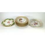 A pair of 19th century decorative plates, hand finished with flowers on a white ground within a